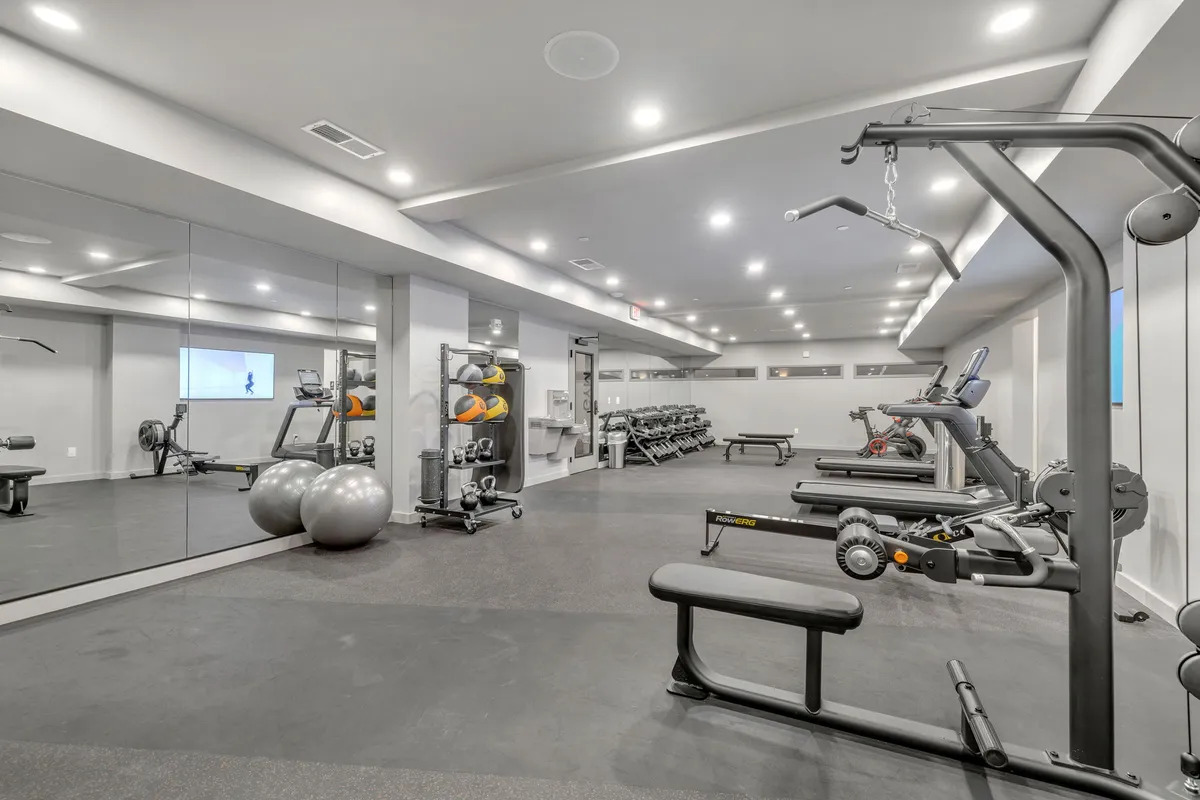 A state-of-the-art gym featuring weight machines, cardio equipment, mirrored walls, and exercise balls. The room is bright and energizing, creating the perfect environment for guests to stay active and pursue their fitness goals.